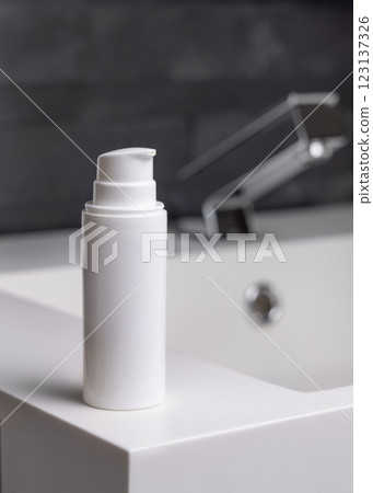 White one pump bottle near modern faucet on basin in dark grey bathroom close up, cosmetic mockup White one pump bottle near modern faucet on basin in dark grey bathroom close up, cosmetic mockup 123137326