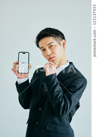 Young man in his 20s with a smartphone iDeCo 123137433