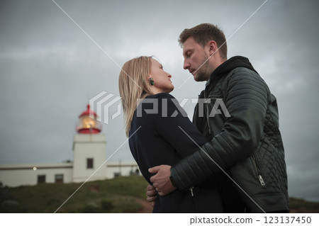 Couple hugging with lighthouse in background at cabo de s o vicente, portugal 123137450