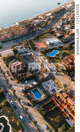 Aerial view of coastal urban development with pools and roads near the sea 123139208