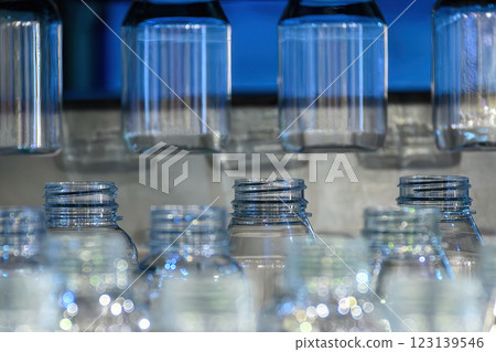 The plastic bottle manufacturing process by vertical blow mold machine. The plastic bottle manufacturing process by vertical blow mold machine. 123139546