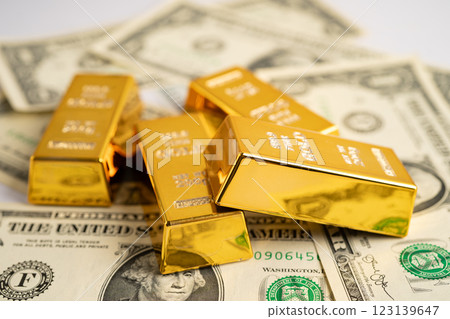 Gold bar on US dollar banknotes money and graph, economy finance exchange trade investment. 123139647