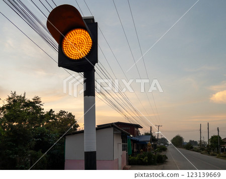 Rural amber traffic light at dusk - Road safety in country. 123139669