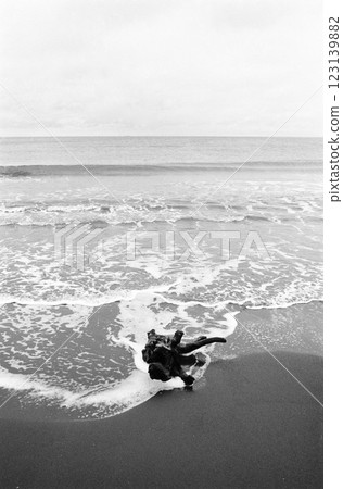 Driftwood washed up on the shore Black and white film image 123139882