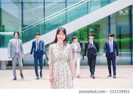 Smiling career woman and her colleague walking outside the office 123139951