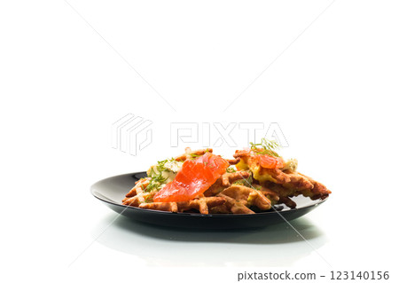 vegetable potato waffles with spread and lightly salted red fish in a plate vegetable potato waffles with spread and lightly salted red fish in a plate 123140156