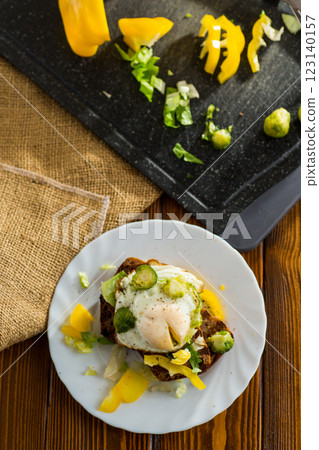 Egg on bread with vegetable garnish Egg on bread with vegetable garnish 123140157