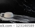 White flour and rolling pin on a black background. Toned. 123140589