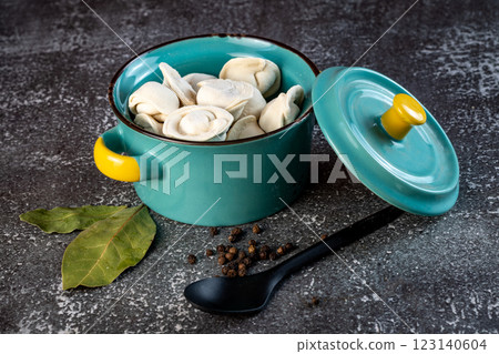 Meat dumplings - russian pelmeni in a bowl on a dark background Meat dumplings - russian pelmeni in a bowl on a dark background 123140604