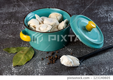 Meat dumplings - russian pelmeni in a bowl on a dark background Meat dumplings - russian pelmeni in a bowl on a dark background 123140605