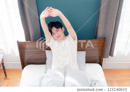 A young man waking up refreshed in the morning sun A young man waking up refreshed in the morning sun 123140633