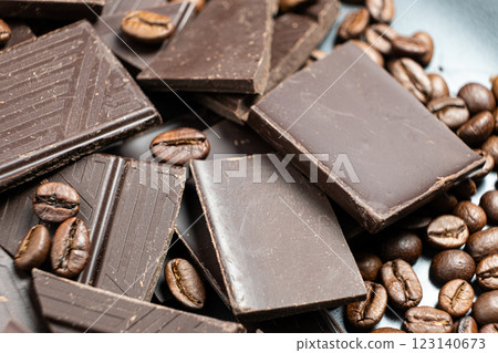 Dark chocolate pieces with coffee beans close-up. Dark chocolate pieces with coffee beans close-up. 123140673