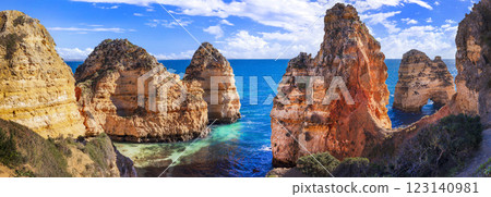 Amazing rocky scenic becahes of Algarve coast, Portugal. Breathtaking yellow rocks with arc .  panoramic view 123140981