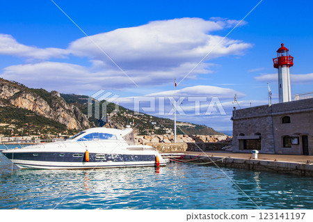Mentone -charming coastal town resort in French riviera. view of marine with speed boat and lighthouse. Cote d'azure, Alpes-maritimes, France 123141197