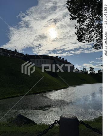 Historic Nesvizh castle with a moat under a bright sky Historic Nesvizh castle with a moat under a bright sky 123141689