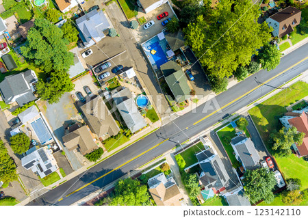 View captures sunny suburban neighborhood with houses, pool, green spaces at Sayreville American town New Jersey View captures sunny suburban neighborhood with houses, pool, green spaces at Sayreville American town New Jersey 123142110