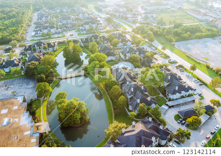 Tranquil homes by sunlit lake, embraced by lush greenery peaceful landscape at Sayreville American town New Jersey 123142114