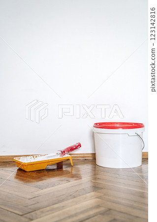White paint in bucket on the home interior decorating wall. Renovation home room White paint in bucket on the home interior decorating wall. Renovation home room 123142816