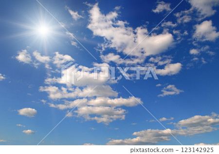 Blue sky with white clouds and bright sun. 123142925