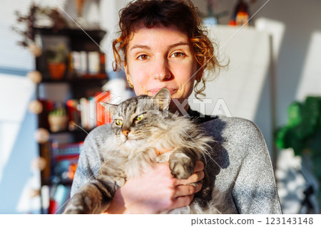 portrait young woman hugging gray fluffy domestic cat portrait young woman hugging gray fluffy domestic cat 123143148