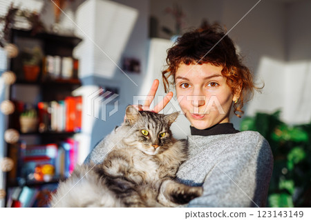 portrait young woman hugging gray fluffy domestic cat portrait young woman hugging gray fluffy domestic cat 123143149