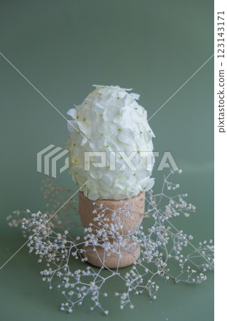 Creative Easter egg shape made of white lilac spring petals flowers. Responsible holidays decoration. Minimal holiday concept still life. Copy space 123143171