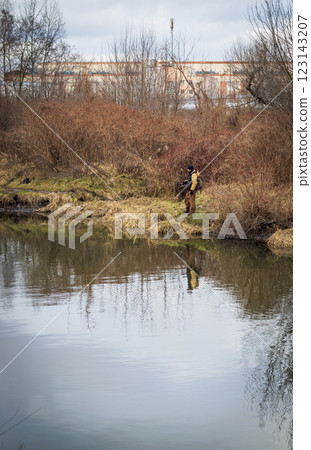 Shot of the man fishing on the winter river 123143207