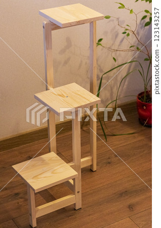 Close up shot of assembled wooden shelf for plants in pots Close up shot of assembled wooden shelf for plants in pots 123143257
