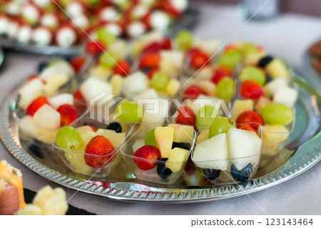 Snacks for the holiday, catering. Various snacks. Assortment of salads, sushi and buffet dishes. Meat, fish, cheese, salads, fruits and vegetables, sauces and canapes for celebrating a festive event. 123143464
