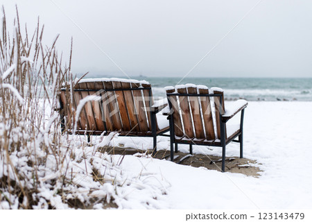 Winter landscape with benches in a fishing village on the seashore - selective focus Winter landscape with benches in a fishing village on the seashore - selective focus 123143479