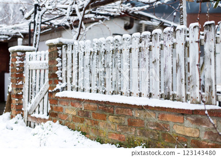 Winter landscape with white vintage fence covered in snow - selective focus Winter landscape with white vintage fence covered in snow - selective focus 123143480