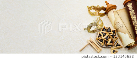 Purim Celebrations. Golden mask, scroll, gragger, and hamantaschen on decorative background 123143688