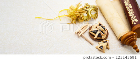 Purim Celebrations. Golden mask, scroll, gragger, and hamantaschen on decorative background Purim Celebrations. Golden mask, scroll, gragger, and hamantaschen on decorative background 123143691