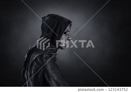 Scary figure with hooded cloak over dark misty background with clipping path 123143752