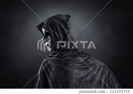 Scary figure with hooded cloak over dark misty background with clipping path Scary figure with hooded cloak over dark misty background with clipping path 123143753