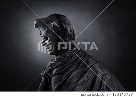 Portrait of a scary medieval clown over dark misty background with clipping path 123143757