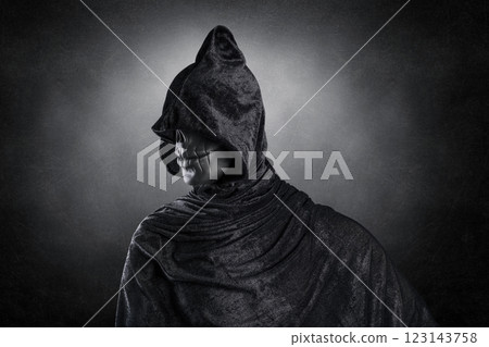 Scary figure with hooded cloak over dark misty background with clipping path 123143758