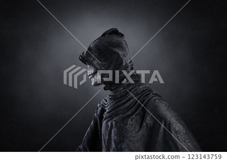 Scary figure with hooded cloak over dark misty background with clipping path 123143759