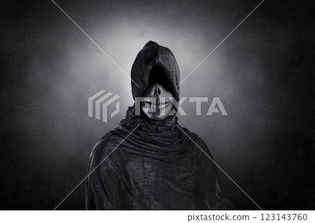 Scary figure with hooded cloak over dark misty background with clipping path 123143760