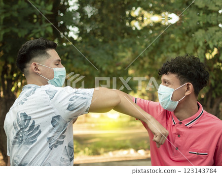 Two young people bumping their elbows, image of two young people bumping their elbows in a friendly way, about two elbows bumping in a friendly way Two young people bumping their elbows, image of two young people bumping their elbows in a friendly way, about two elbows bumping in a friendly way 123143784
