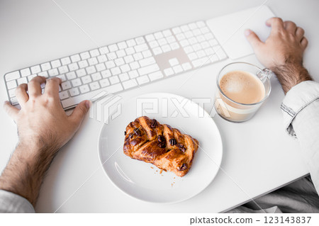 Male caucasian adult enjoying coffee and pastry at workspace Male caucasian adult enjoying coffee and pastry at workspace 123143837
