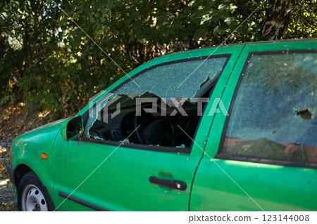 Broken glass on the passenger door of a passenger car parked. The concept of crime of car theft, theft of valuables 123144008