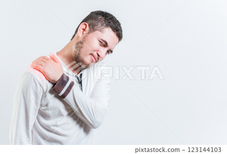 Person with shoulder muscle pain on isolated background. Unhappy man with shoulder pain isolated 123144103