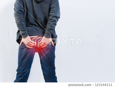 Person with hemorrhoid problem isolated. Unrecognizable man with hemorrhoids and constipation problems 123144111
