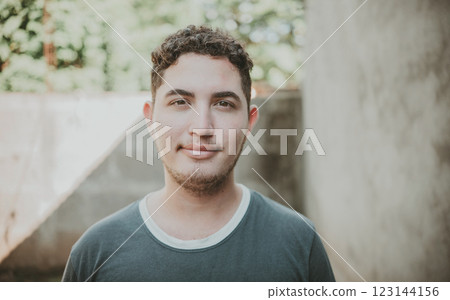Portrait of cheerful young latin guy smiling at camera outdoors. Portrait of Latin American man looking and smiling at the camera 123144156