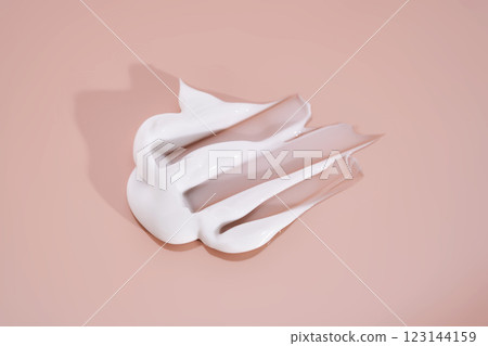The texture of white cream on a pink background. 123144159