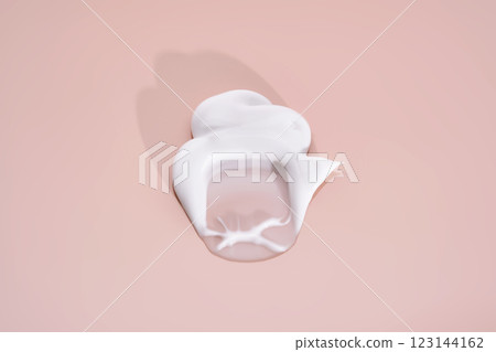 The texture of white cream on a pink background. The texture of white cream on a pink background. 123144162