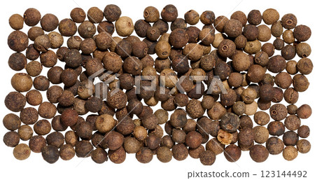 A collection of dried allspice berries arranged in a scattered on isolated background 123144492