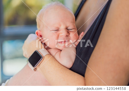 A mother lovingly embraces her newborn baby, holding them close to her chest. A tender moment of warmth, security, and deep maternal love, symbolizing bonding, comfort, and the unbreakable connection A mother lovingly embraces her newborn baby, holding them close to her chest. A tender moment of warmth, security, and deep maternal love, symbolizing bonding, comfort, and the unbreakable connection 123144558