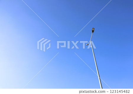 A beautifully Clear Blue Sky with a bright Streetlight illuminating the surroundings 123145482